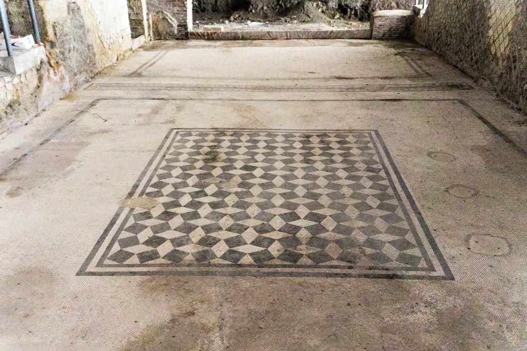 Herculaneum Villa dei Papiri. October 2023. Room l (L), triclinium, looking east across flooring. Photo courtesy of Johannes Eber.